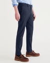 Side view of model wearing Navy Blazer Alpha Chino Pants, Slim Fit.