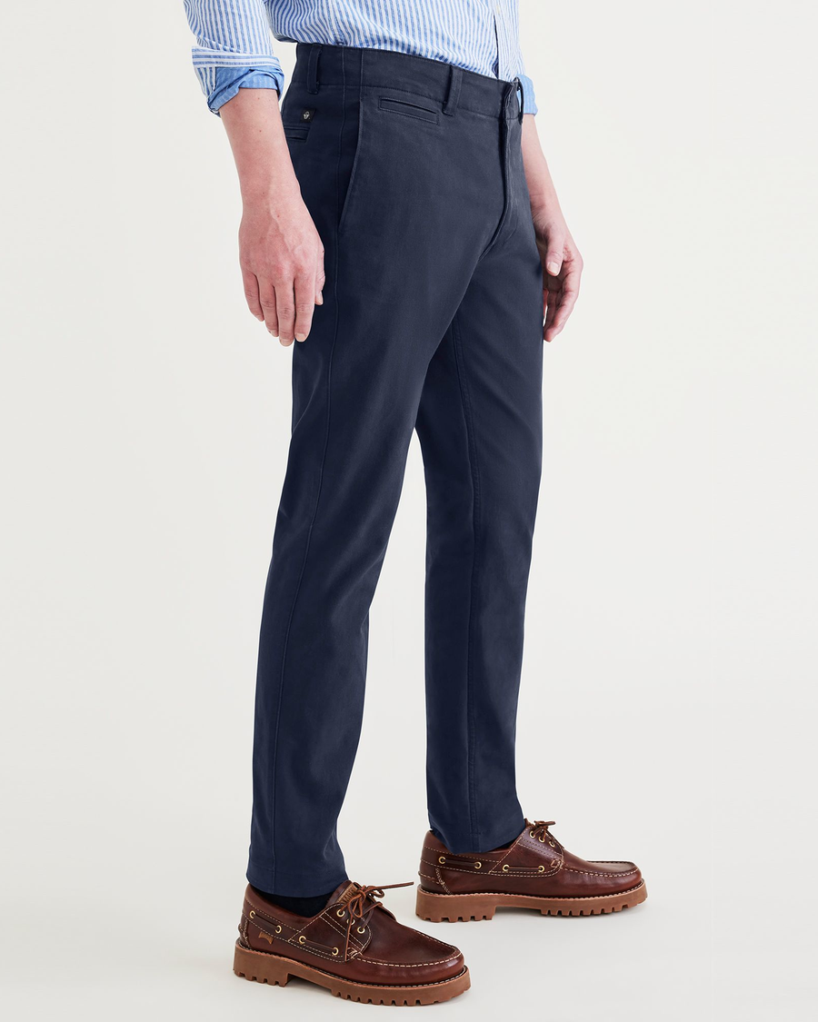 Side view of model wearing Navy Blazer Alpha Chino Pants, Slim Fit.