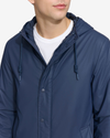 View of model wearing Navy Blazer Men's Lightweight Rain Jacket.