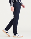 Side view of model wearing Navy Blazer Men's Slim Tapered Fit Refined Pull-On Pants.