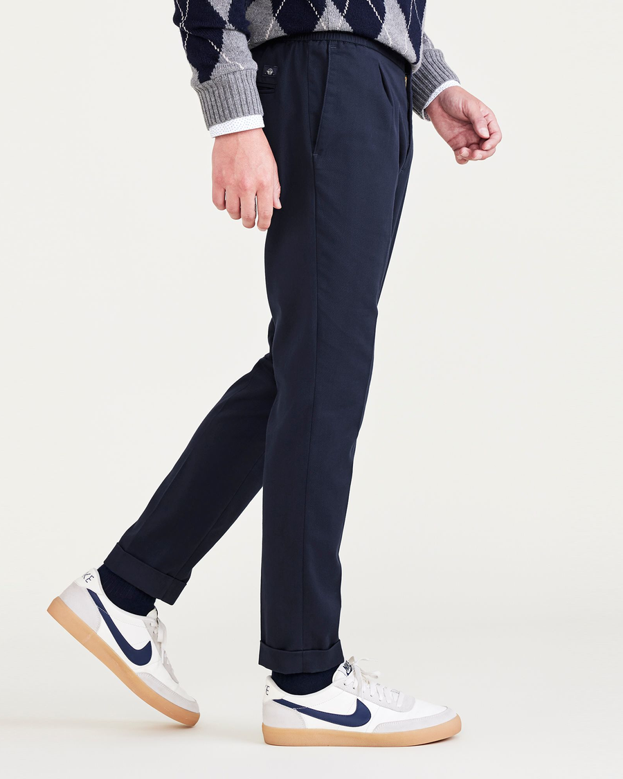 Side view of model wearing Navy Blazer Men's Slim Tapered Fit Refined Pull-On Pants.