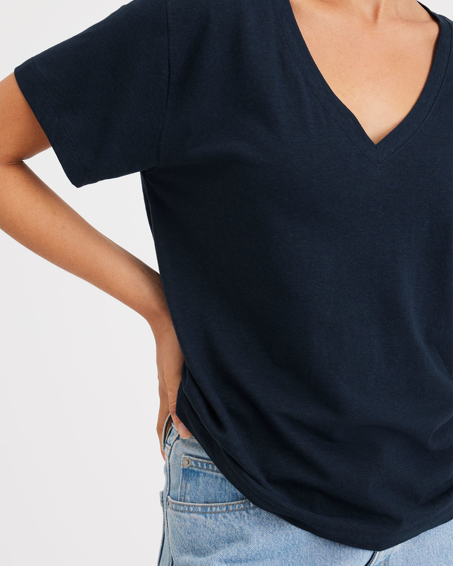View of model wearing Navy Blazer Women's Deep V-Neck Tee Shirt.