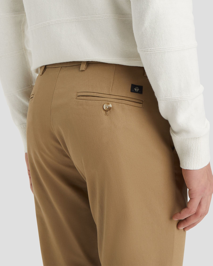 View of model wearing New British Khaki Signature Iron Free Khakis, Slim Fit with Stain Defender®.