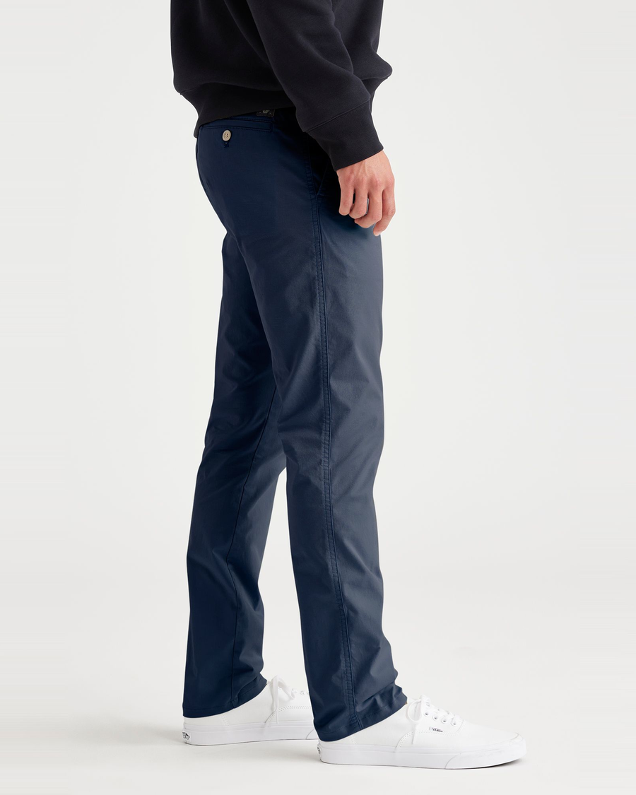 Side view of model wearing Ocean Blue Men's Skinny Fit Original Chino Pants.