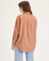 Back view of model wearing Peach Bloom Women's Relaxed Fit Original Shirt.