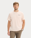 Front view of model wearing Peach Blush Graphic Tee, Regular Fit.