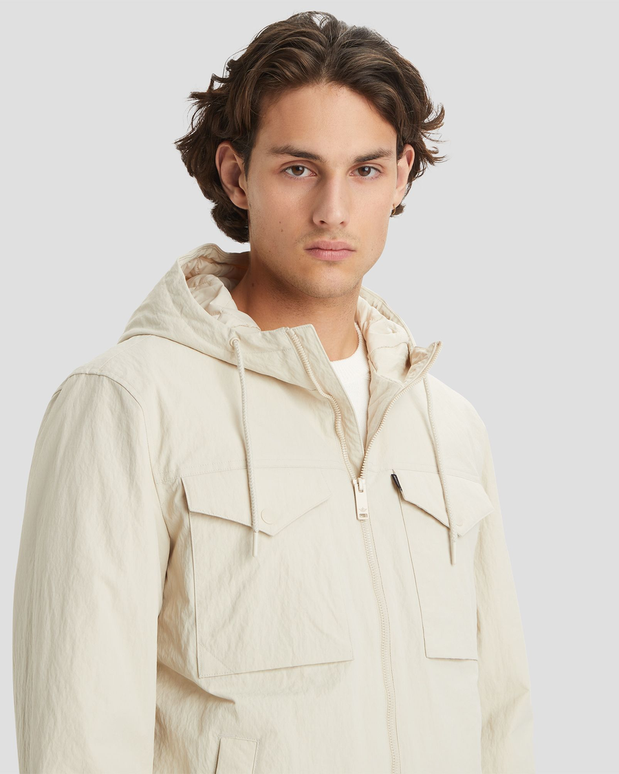 View of model wearing Sahara Khaki Men's Sail Recycled Nylon Jacket.
