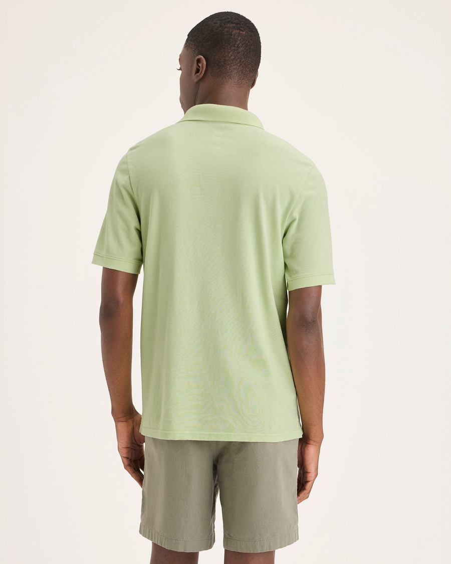 Back view of model wearing Seedling Men's Slim Fit Pique Polo.