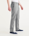 Side view of model wearing Sharkskin Men's Slim Fit Smart 360 Flex California Chino Pants.