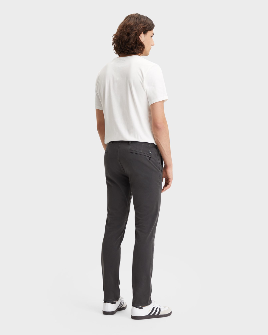 Back view of model wearing Steelhead Men's Skinny Fit Smart 360 Flex Alpha Khaki Pants.