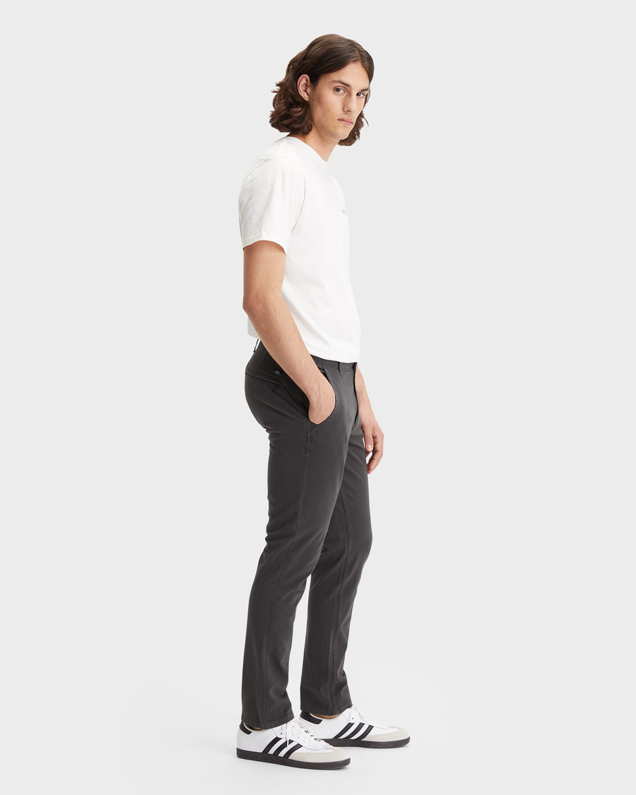 Side view of model wearing Steelhead Men's Skinny Fit Smart 360 Flex Alpha Khaki Pants.