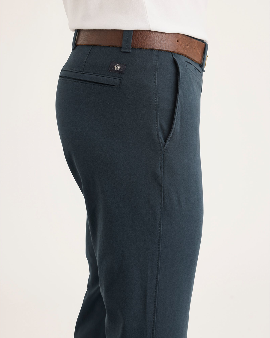 Side view of model wearing Stratified Sea Men's Skinny Fit Smart 360 Flex California Chino Pants.