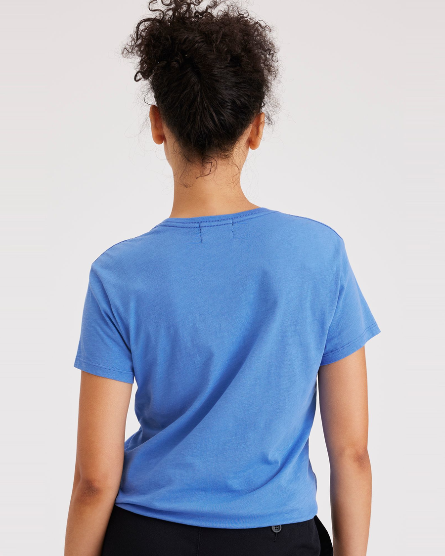 Back view of model wearing Sumi Flowers Ceramic Blue Women's Slim Fit Graphic Tee Shirt.