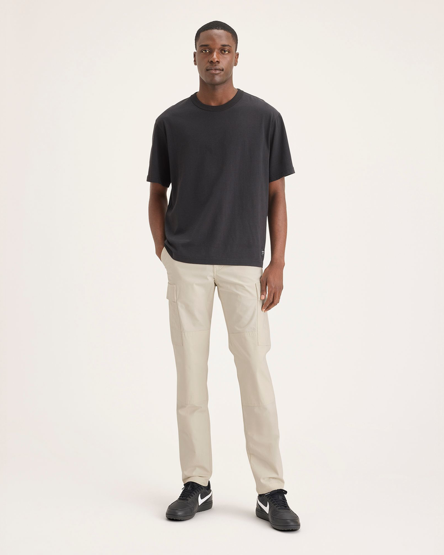 Front view of model wearing Summer Earth Men's Cargo Slim Tapered Fit Pants.