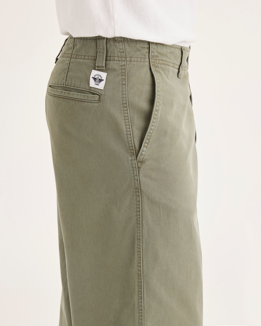 Side view of model wearing Tea Leaf Eighty-Six Alpha Chino Pants, Loose Fit.