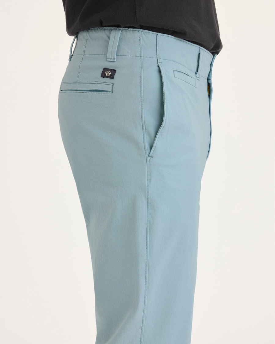 Side view of model wearing Tourmaline Alpha Chino Pants, Slim Fit.